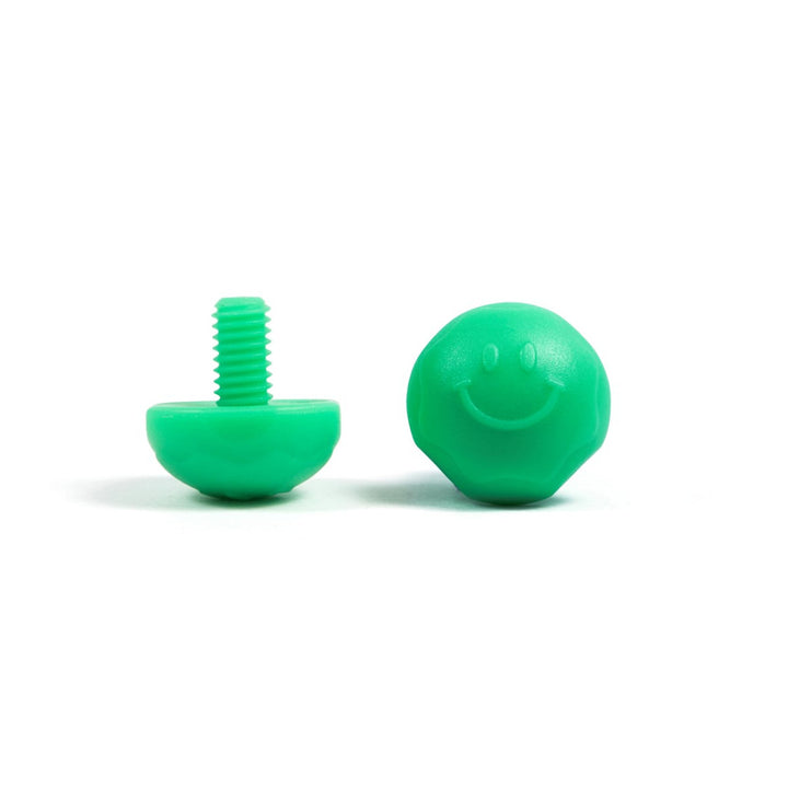A pair of green bolt-on toe plugs for roller skates, displayed on a plain background.