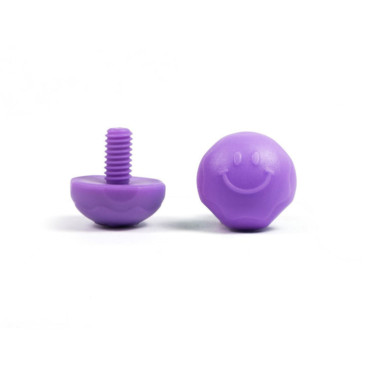 A pair of purple bolt-on toe plugs for roller skates, displayed on a plain background.