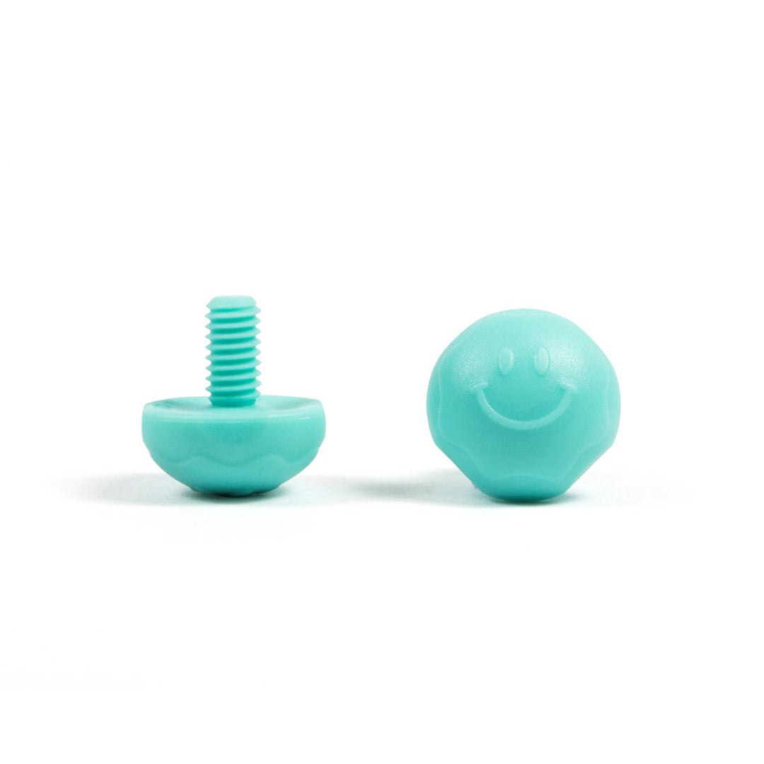 A pair of teal bolt-on toe plugs for roller skates, displayed on a plain background.