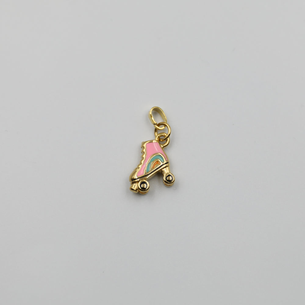 Gold charm shaped like a pink roller skate with rainbow details on a gray background