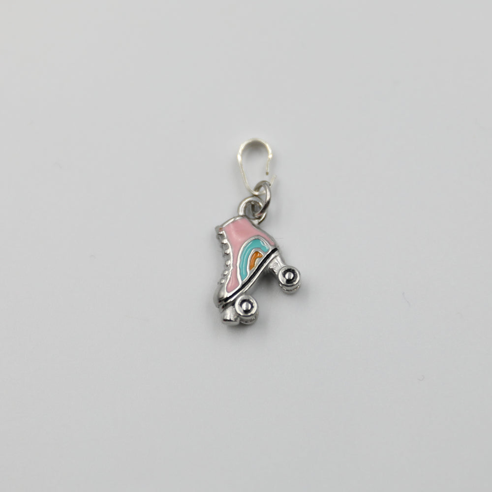 Pink and silver roller skate charm on a white background