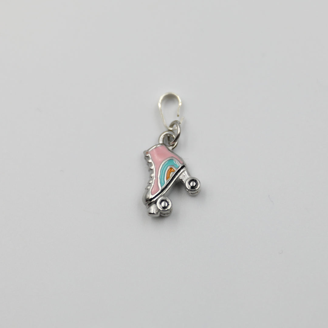 Pink and silver roller skate charm on a white background