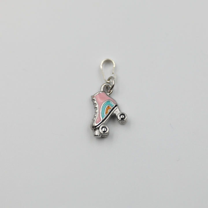 Pink and silver roller skate charm on a white background