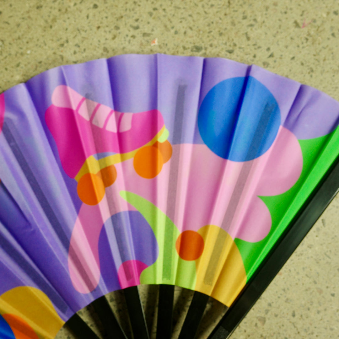 RollerFit Sweat Skate Repeat handheld fans with purple, orange, pink, yellow, green and blue design