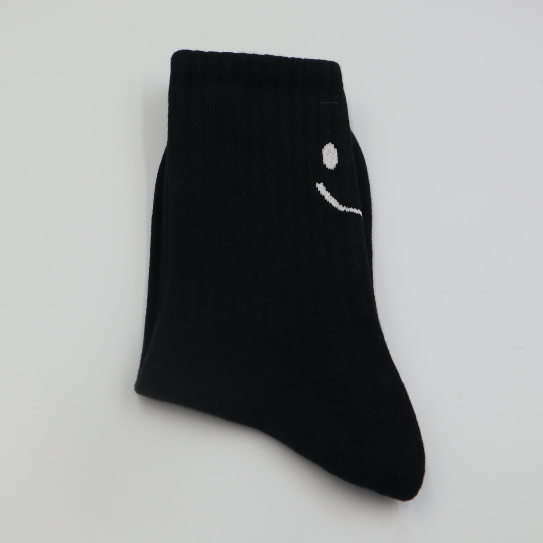 RollerFit ribbed crew socks with a smiley face eyes and mouth design above the heel: black with white smiley face
