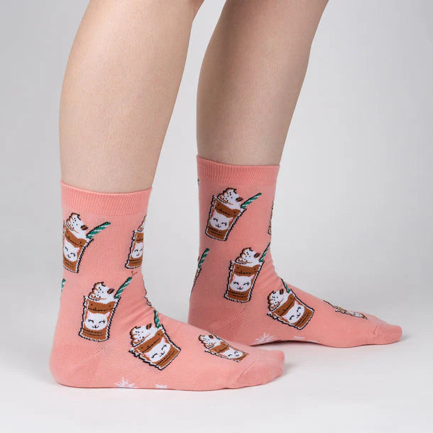 Pink socks with cat-themed design on a plain background
