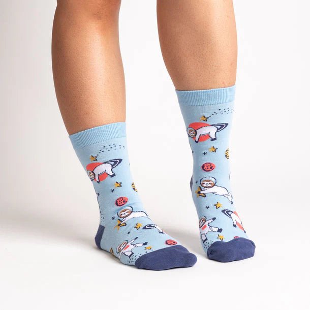 Light blue socks with space-themed design worn by a person on a white background