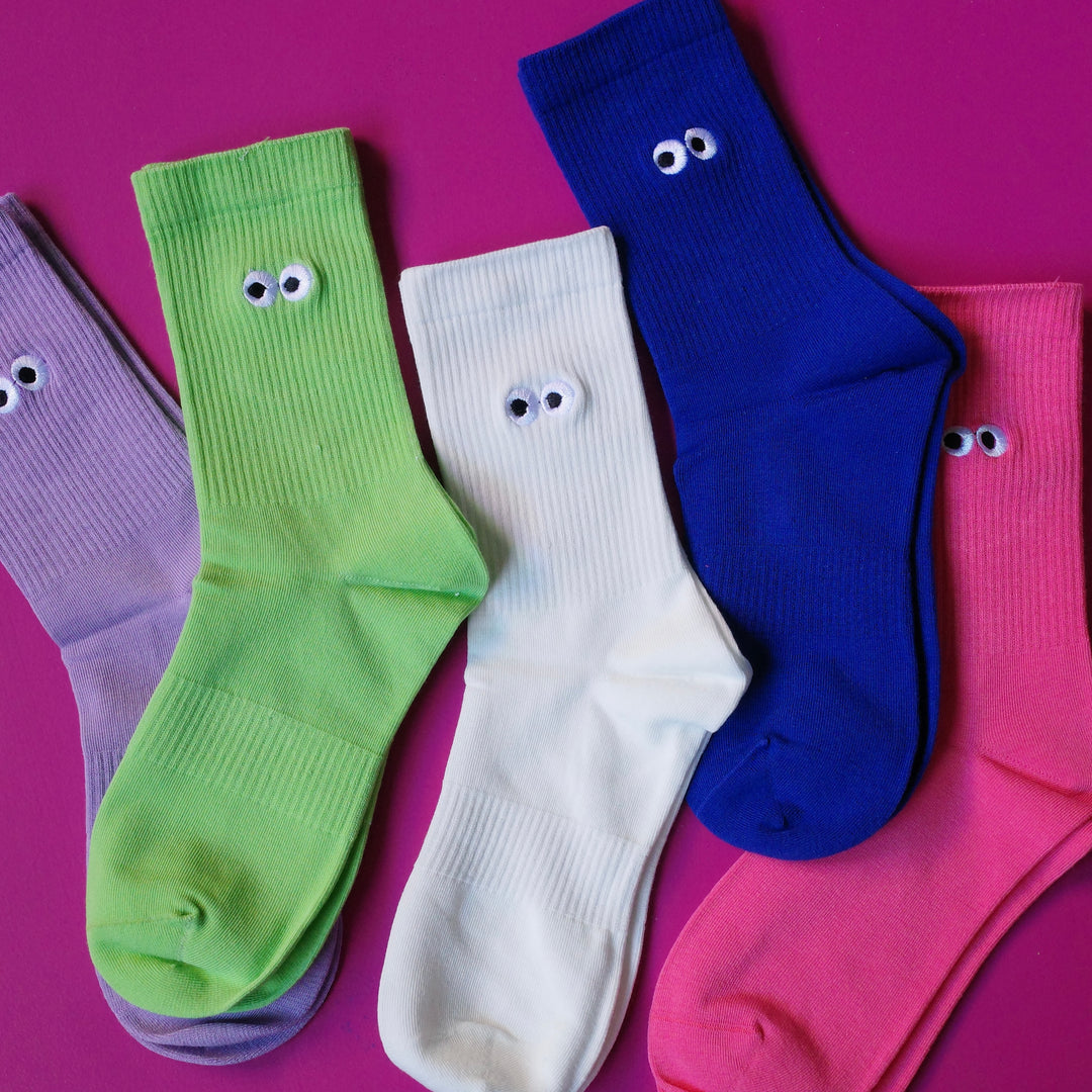 Bright coloured crew socks with embroidered cartoon eyeball design