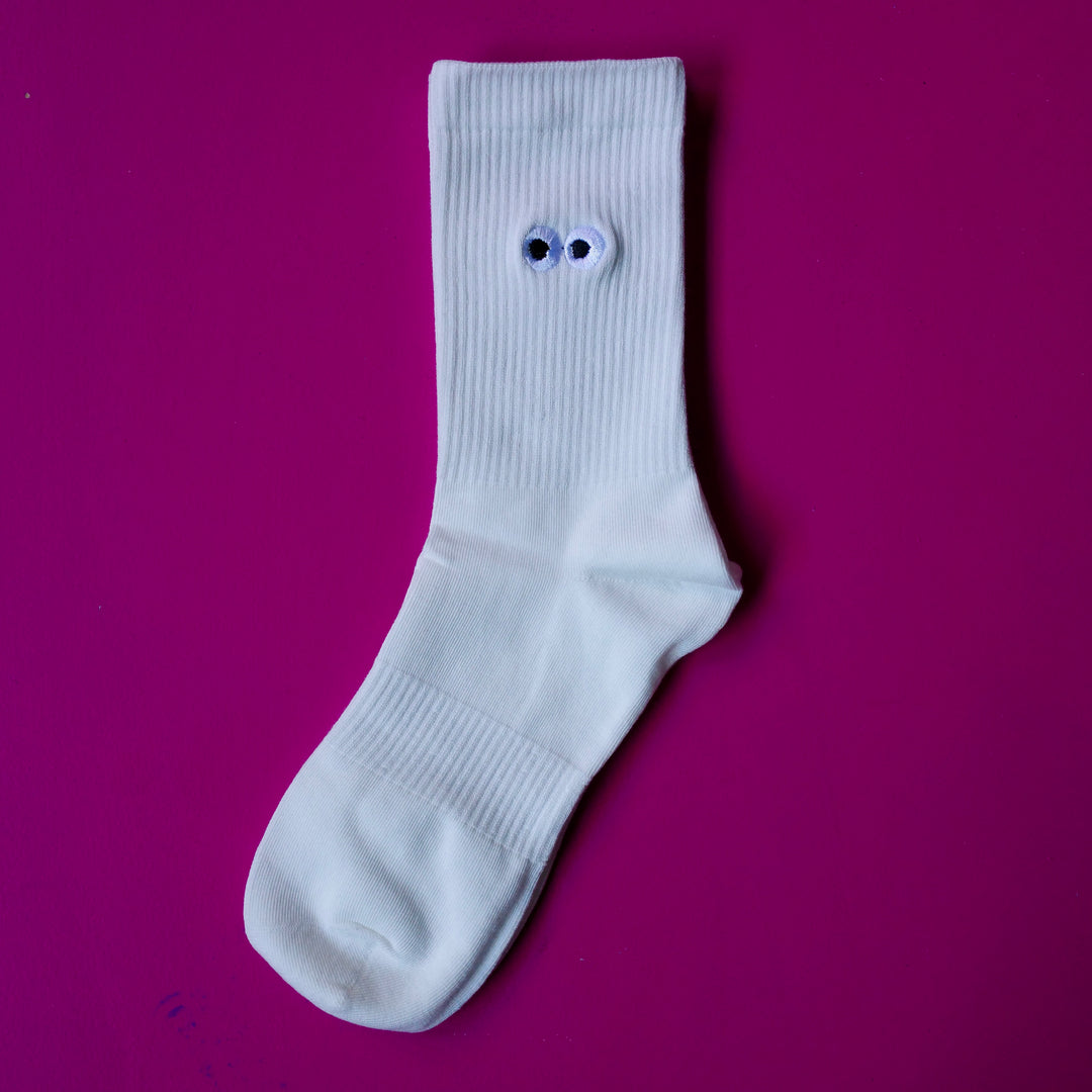 White crew socks with embroidered cartoon eyeball design
