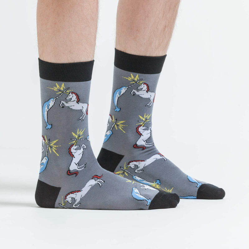 Grey socks with cartoon narhwal and unicorn clashing horns.