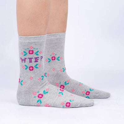 Grey marle socks with pink, purple and teal floral cross stich motifs and "WTF?" text.