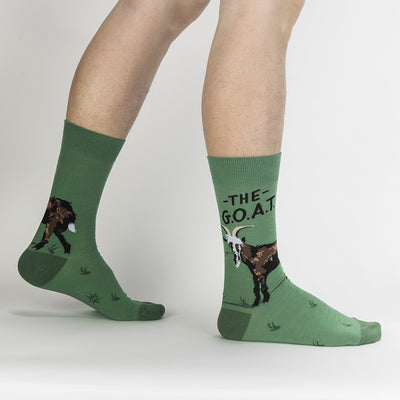 Green socks with a goat and text "THE G.O.A.T".
