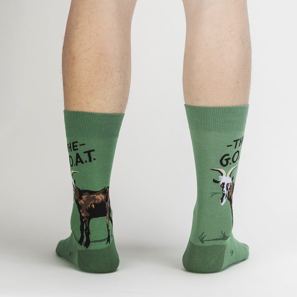 Green socks with a goat and text "THE G.O.A.T".