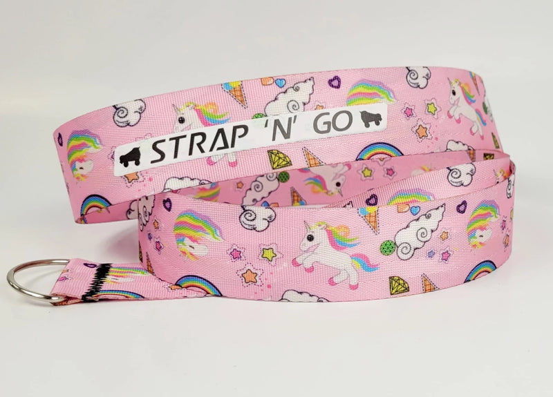 Strap N Go skate leash in Unicorn Galaxy print: a pastel pink background with cartoon stars, gems, clouds and rainbow unicorns