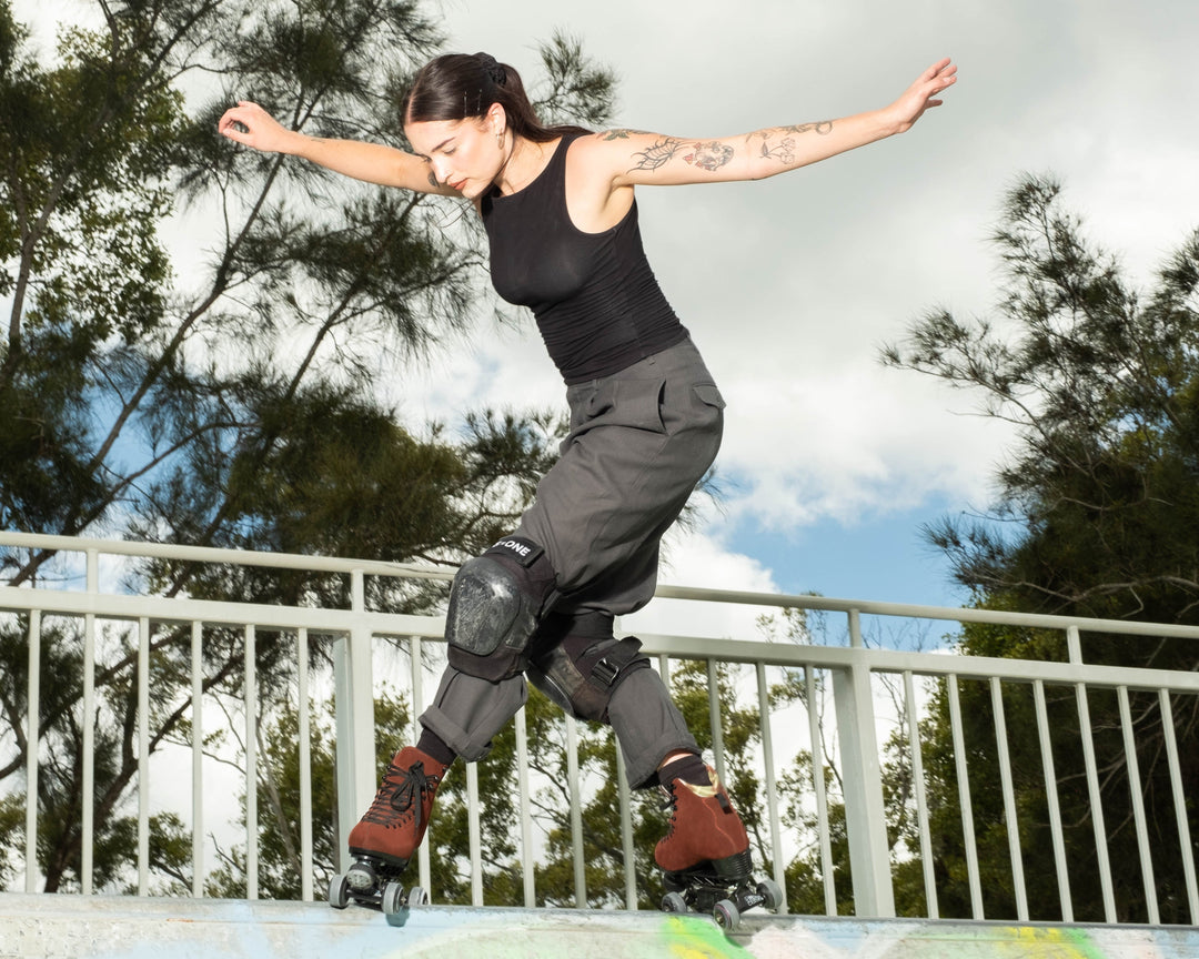 Roller skater Jade does a tabernacle slide on a metal mini ramp. 