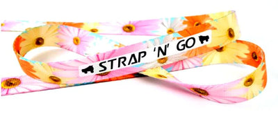 Strap N Go skate leash in daisy print with white, pink, yellow and orange daisies.