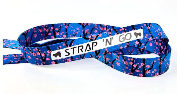 Strap N Go skate leash in cherry blossom print with royal blue background.