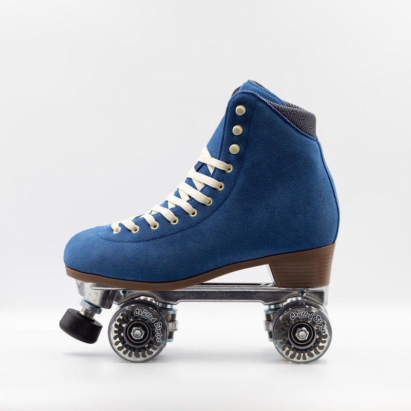 Chuffed Skates Wanderer roller skates in classic blue with cream laces and eyelets, black toe stop, and clear wheels.