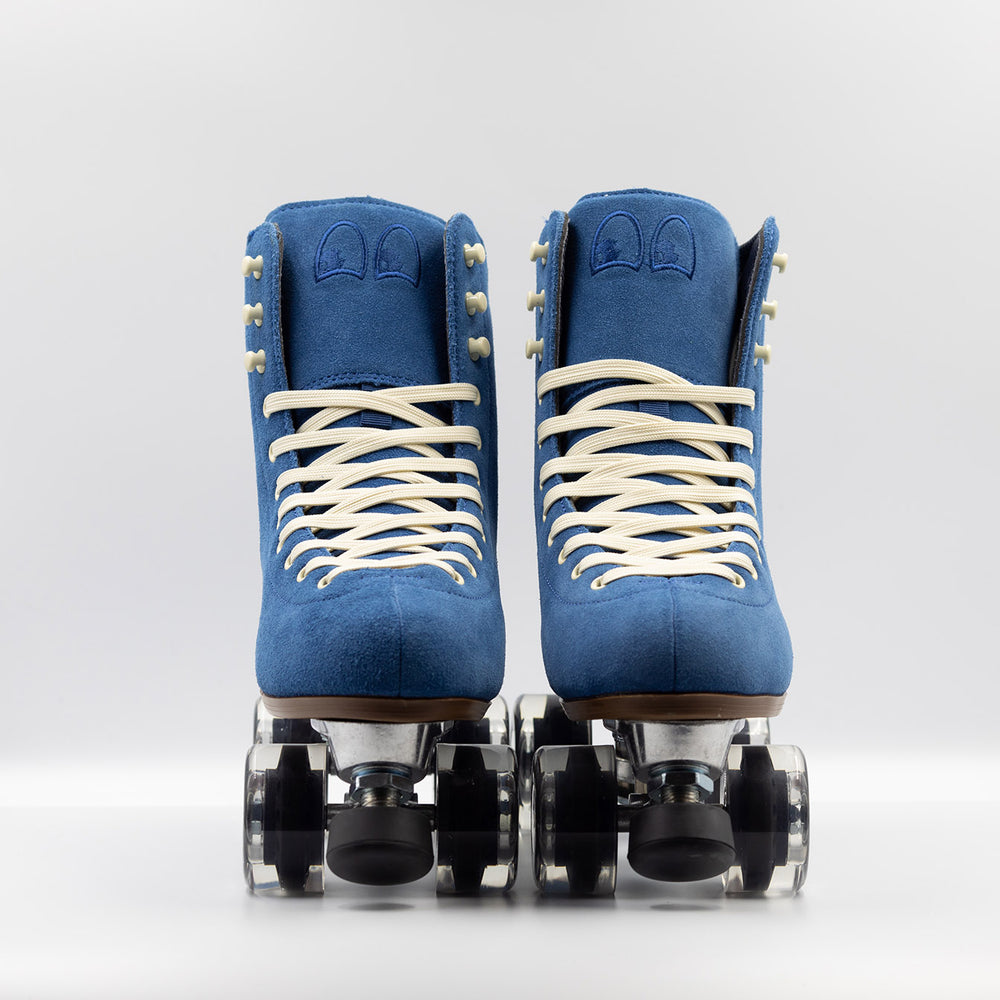 Chuffed Skates Wanderer roller skates in classic blue with cream laces and eyelets, black toe stop, and clear wheels.