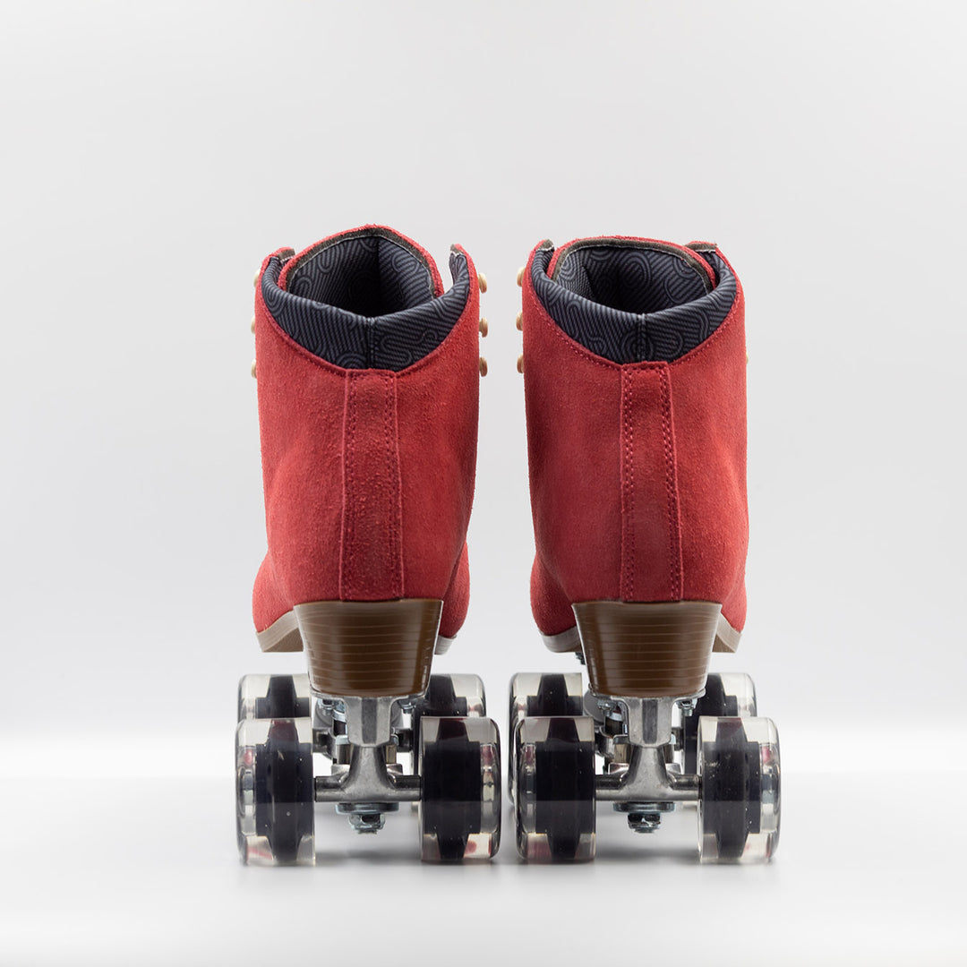 Chuffed Skates Wanderer roller skates in watermelon red with cream laces and eyelets, black toe stop, and clear wheels.