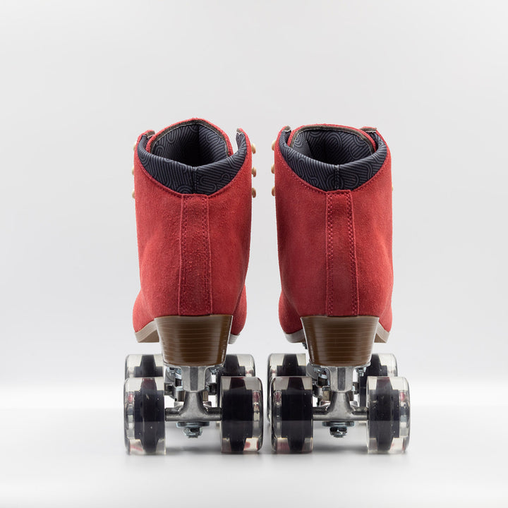 Chuffed Skates Wanderer roller skates in watermelon red with cream laces and eyelets, black toe stop, and clear wheels.