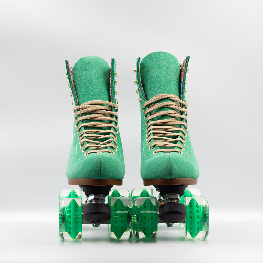 Moxi Roller Skates Lolly roller skate in Green Apple with oyster laces, black plate and toe stops, and matching green wheels.
