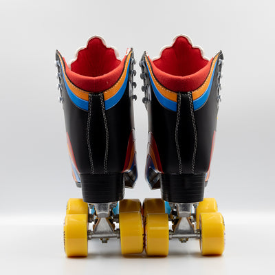 Moxi Roller Skates Rainbow Riders in Asphalt Black with white tongue, yellow wheels and blue toe stops.