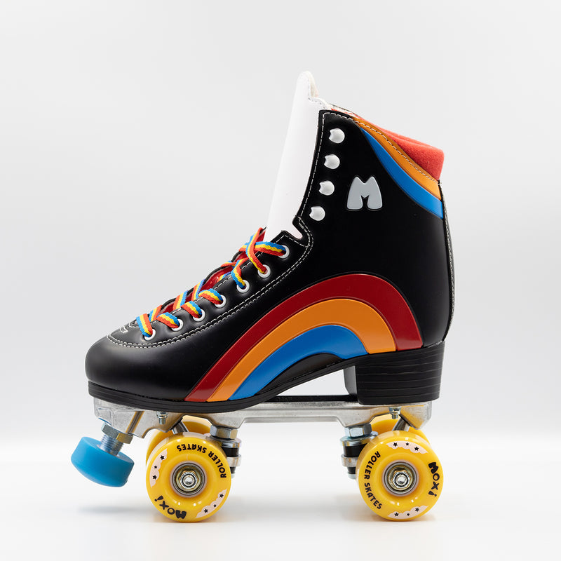 Moxi Roller Skates Rainbow Riders in Asphalt Black with white tongue, yellow wheels and blue toe stops.