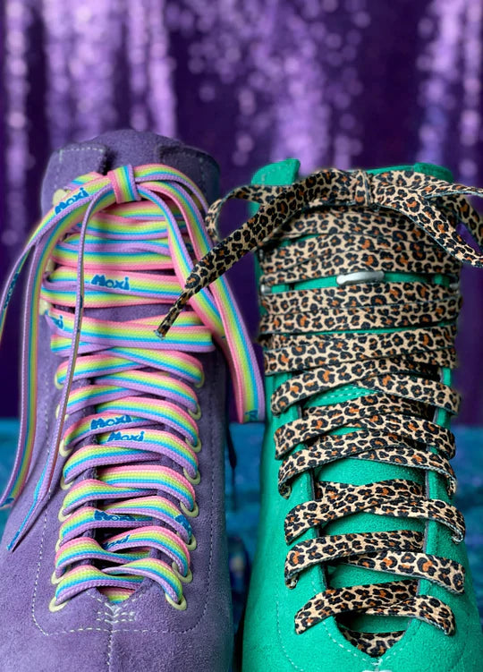 Purple roller skate with pastel rainbow laces and green roller skate with leopard print laces.