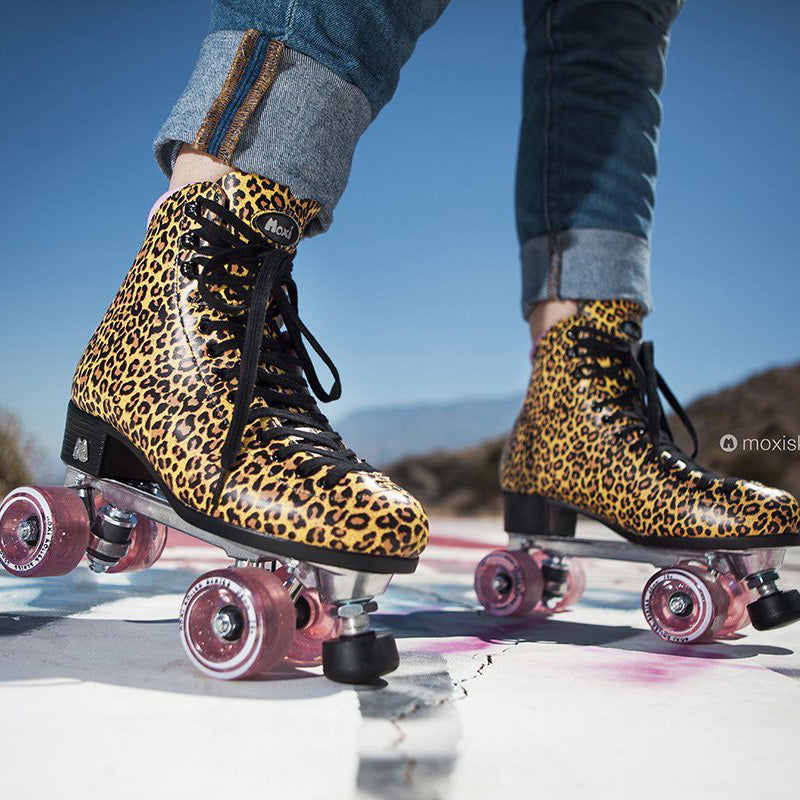 Moxi Roller Skates Jungle leopard print roller skates with pink lining and wheels.