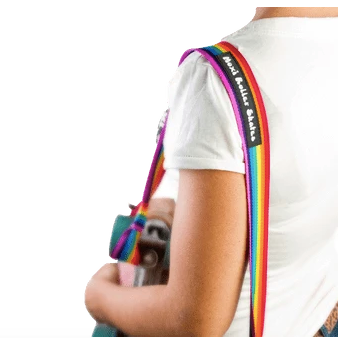 Moxi Roller Skates skate leash in rainbow holding skates and slung over a persons shoulder.
