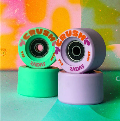 Radar Crush wheels in Lavender and Seafoam green on a colourful, textured background.