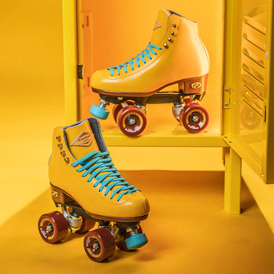 Riedell Crew roller skates in Turmeric yellow with blue laces and toe stop and crimson red wheels.