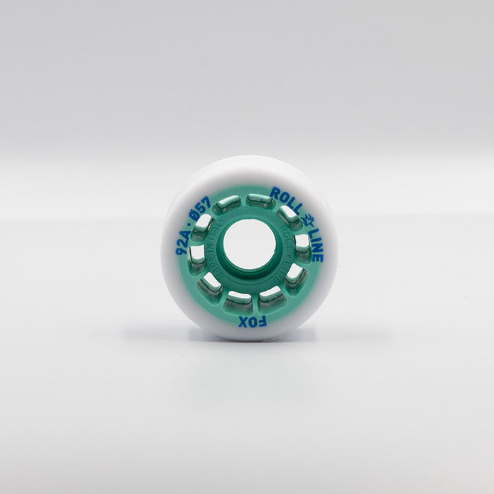 Roll-Line Fox wheels, white tread with teal hub.