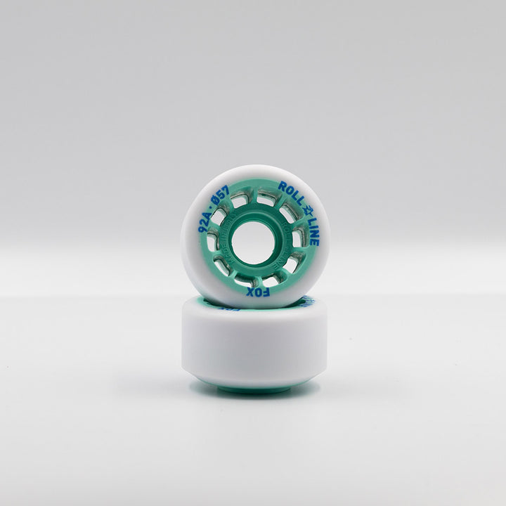 Roll-Line Fox wheels, white tread with teal hub.