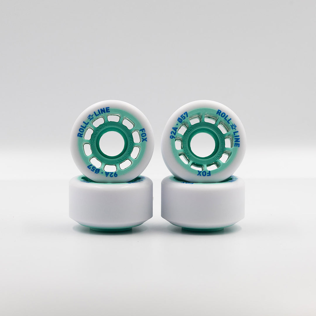 Roll-Line Fox wheels, white tread with teal hub.