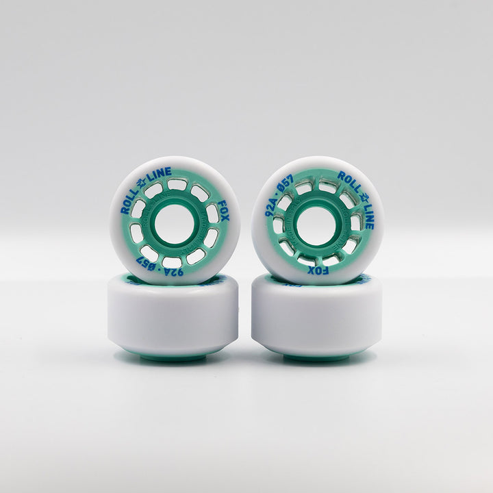 Roll-Line Fox wheels, white tread with teal hub.