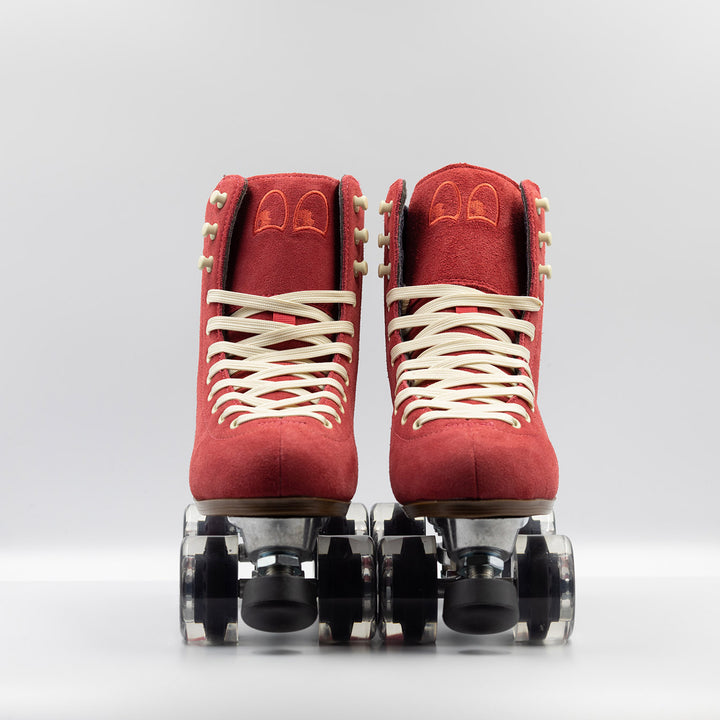 Chuffed Skates Wanderer roller skates in watermelon red with cream laces and eyelets, black toe stop, and clear wheels.