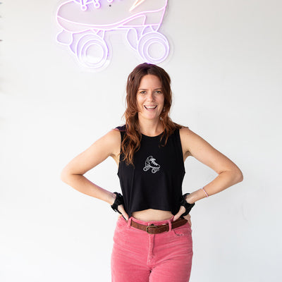 Stacey wears the RollerFit classic skate tank in black with pink pants.