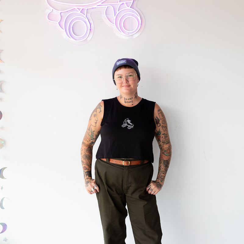 Linda wears the RollerFit classic skate tank in black with army green pants.