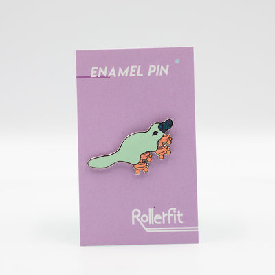 RollerFit enamel pin platypus in aqua with orange glitter skates and glitter dark teal beak.
