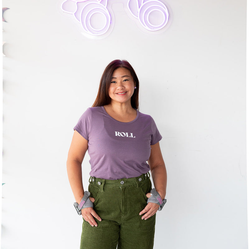 Jenn wears the RollerFit Roll mauve scoop neck t shirt with green pants.