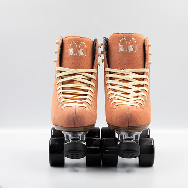 Chuffed Skates Wanderer Roller Skates in Peach Pink with cream laces and embroidered Chuffed eye logo on tongue, black wheels and toe stop.