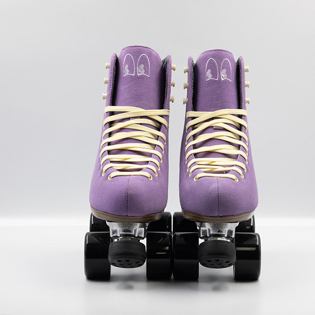 Chuffed Skates Wanderer roller skates in Jacaranda Purple with cream laces, eyelets and logo embroidery on the tongue, black wheels and toe stops.