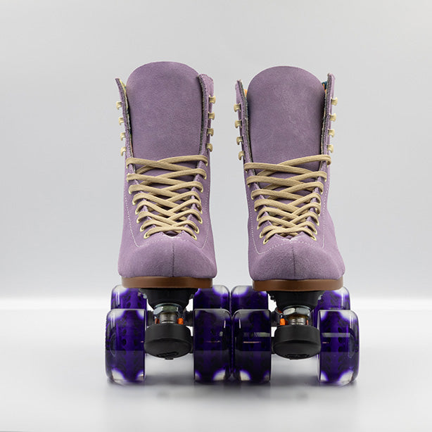 Moxi Roller Skates Lolly roller skates in Lilac with oyster laces and eyelets, tan sole, black plate and toe stop, matching purple wheels.