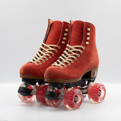 Moxi Roller Skates Lolly roller skates in Poppy red with oyster laces and eyelets, tan sole, black plate and toe stop, matching red wheels.