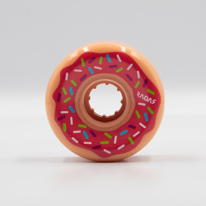 Radar Donut wheel, creamy orange with fuchsia icing look and colourful sprinkles.