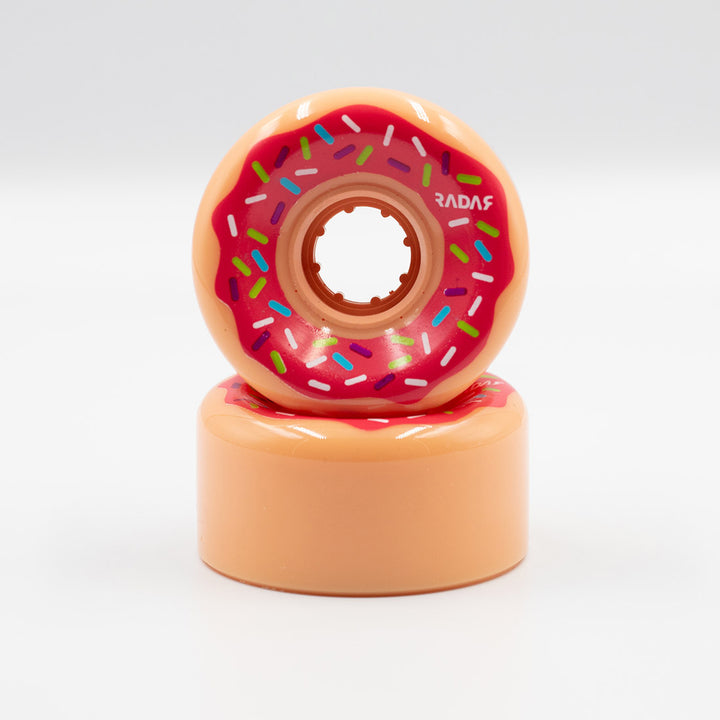 Radar Donut wheel, creamy orange with fuchsia icing look and colourful sprinkles. 