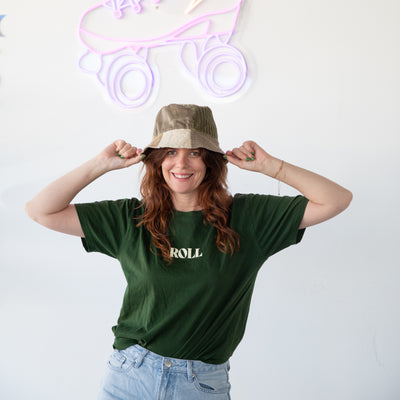 Stacey wear the Roll t-shirt in Forest Green with denim pants and corduroy bucket hat.