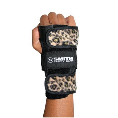Hand in a fist wearing a leopard brown Smith Scabs wrist guard.
